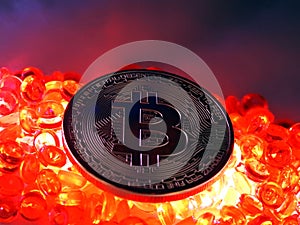 Bitcoin coin on top of red hot burning beats