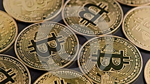 Bitcoin coins on black background - closeup full-frame spinning background