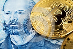 Bitcoin coins on Chilean banknote close up image. Bitcoin with Chilean pesos banknote.