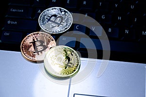 Bitcoin coins on compuer keyboard,symbol of electronic virtual money and mining cryptocurrency concept.Coin crypto currency