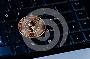 Bitcoin coins on compuer keyboard,symbol of electronic virtual money and mining cryptocurrency concept.Coin crypto currency