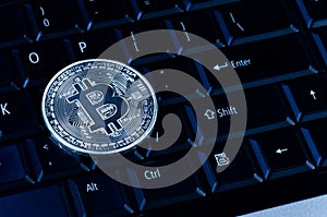 Bitcoin coins on compuer keyboard,symbol of electronic virtual money and mining cryptocurrency concept.Coin crypto currency