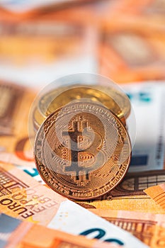 Bitcoin coins and Euro banknotes