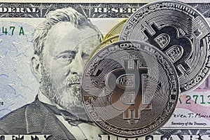 bitcoin coins on fifty dollar bill