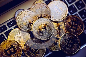 Bitcoin coins on laptop keyboard. Cryptocurrency background.