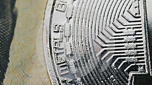 bitcoin coins lie on a dollar bill