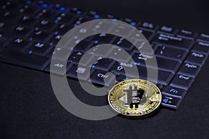 Bitcoin with computer keyboard and golden coin