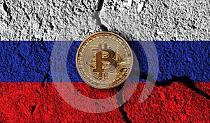 Bitcoin crypto currency coin with cracked Russia flag. Crypto restrictions