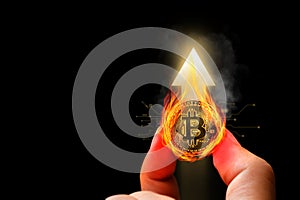 Bitcoin or crypto currency has seen a hot positive increase in price. Holding gold coins in hand with flames with upward arrow