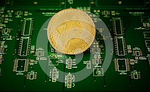 Bitcoin cryptocurrency against electronic board background