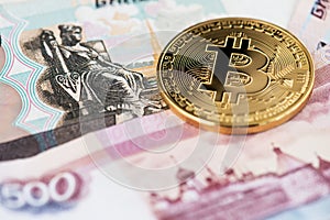 Bitcoin cryptocurrency BTC coin on the background of Russian Rubles.