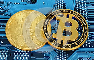Bitcoin cryptocurrency coins on circuit board background