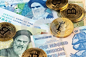 Bitcoin Cryptocurrency Coins on Iran Rial and Zimbabwe hyperinflation Dollar banknotes.
