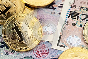 Bitcoin Cryptocurrency Coins and Japanese Yen banknotes.