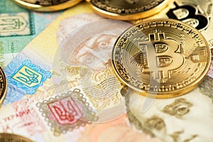 Bitcoin BTC cryptocurrency and Ukraine Hryvnia national currency. photo