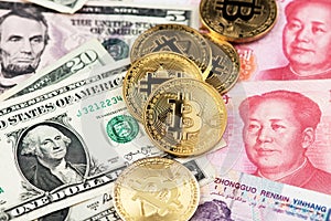 Bitcoin Cryptocurrency coins and US Dollar and Yuan China currency banknotes.