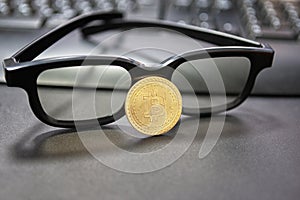 Bitcoin cryptocurrency concept.Glasses and desktop keyboard at background. stock and exchange ocupation