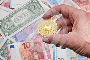 Bitcoin cryptocurrency with dollar and euro banknotes