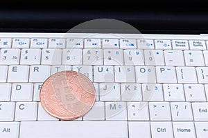 Bitcoin cryptocurrency gold coin on a laptop keyboard . Financial crisis. Digital money. Blockchain technology.