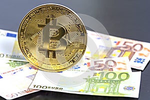 Bitcoin cryptocurrency. Golden bitcoin on euro banknotes background. Bitcoin crypto currency, Blockchain technology, digital money