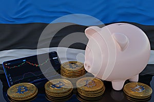 Bitcoin and cryptocurrency investing. Estonia flag in background. Piggy bank, the of saving concept. Mobile application for