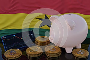 Bitcoin and cryptocurrency investing. Ghana flag in background. Piggy bank, the of saving concept. Mobile application for trading
