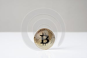 Bitcoin cryptocurrency physical coin standing upright on desk