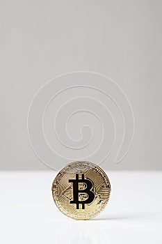 Bitcoin cryptocurrency physical coin standing upright on desk