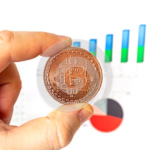 Bitcoin cryptocurrency symbol in hand on the white background