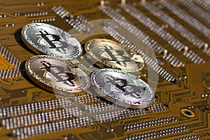 Golden silver crypto currency coin on motherboard. Shiny closeup crypto-currency coin background. Electronic money, cryptocurrency