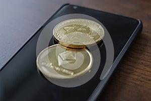 A bitcoin and etherium token on a cell phone