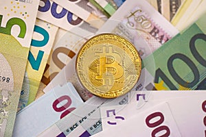 Bitcoin with euro and dollar money bills close up. Big amount of money and bit coin on table. Business and cryptocurrency concept