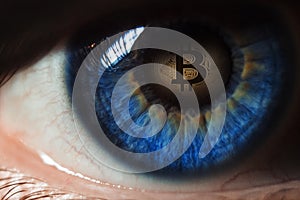 Eye of a person with the bitcoin