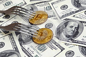 Bitcoin getting New Hard Fork Change, Physical Golden Crytocurrency Coin under the fork on the dollars background. Blockchain Tra