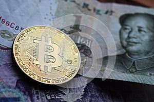 Bitcoin Gold Coin on Chinese Yuan banknotes