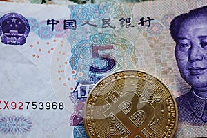 Bitcoin Gold Coin on Chinese Yuan banknotes