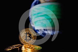 Bitcoin gold coin on globe background