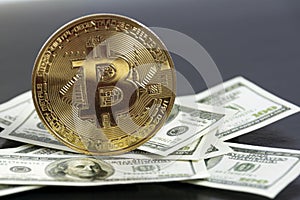 Bitcoin gold coin new virtual money and US dollars banknote. Exchange bitcoins to dollar. Conceptual image for a worldwide