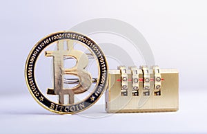 Bitcoin gold coin with padlock lying on white background. Bitcoin security.