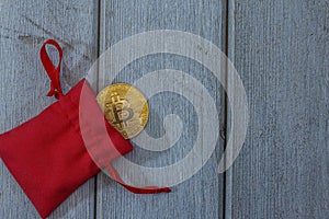 bitcoin gold coin in a red velvet pouch. Online payment technology, digital wallet, cryptocurrency trading and mining