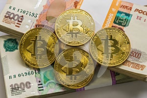Bitcoin gold and the Russian ruble. Bitcoin coin on the background of Russian rubles.