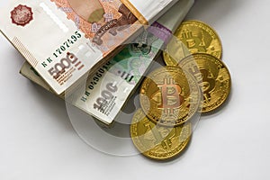 Bitcoin gold and the Russian ruble. Bitcoin coin on the background of Russian rubles.