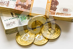 Bitcoin gold and the Russian ruble. Bitcoin coin on the background of Russian rubles.