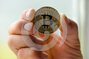 Bitcoin in hand close up