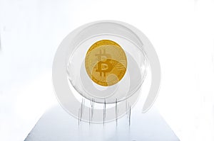 Bitcoin inside a bubble over a needles bed simulating the fragility of this speculative currency