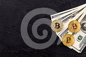 Bitcoin with international currency banknotes on black background top view space for text