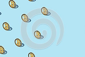 Bitcoin izometric pattern on bright light blue background.