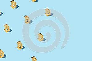 Bitcoin izometric pattern on bright light blue background.