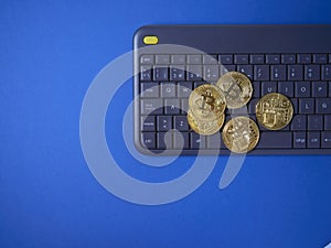 Bitcoin on keyboard dark blue background