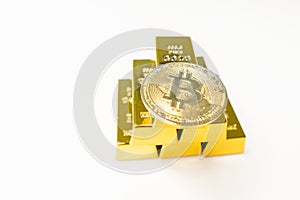 Bitcoin laying on stacked gold bars gold ingots rendered with shallow depth of field. Bitcoin as desirable as gold concept